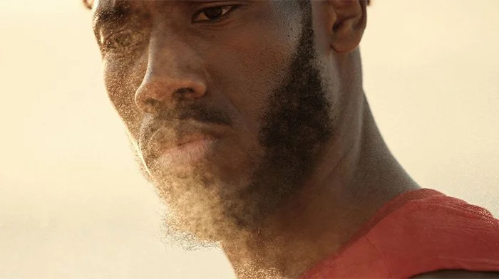 A close up of a young man mid-exercise.