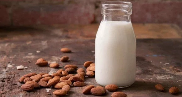Glass bottle of fresh almond milk